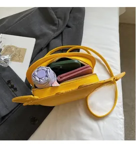 Interior view of yellow crab-shaped crossbody bag showing large capacity for daily items