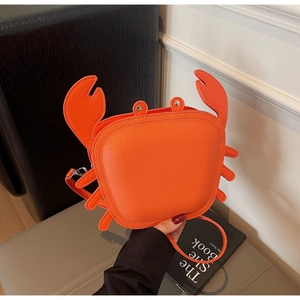 Detail of creative orange crab-shaped crossbody bag with lychee texture and metal rivets