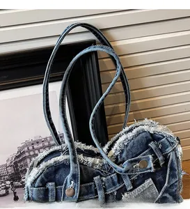 Detail of denim heart bag featuring vintage distressed edges and jean waist structure