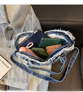 Top view of large capacity blue denim shoulder bag showing interior storage space