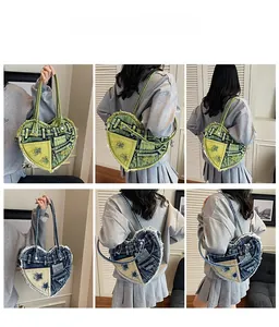 Detail showing distressed heart-shaped denim handbag with multiple pockets and frayed edges