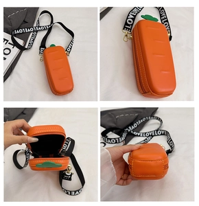 Detail view of carrot crossbody bag showing interior capacity and wide logo strap