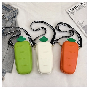 Detail of creative carrot mini bags in orange, white and green with LOVE strap