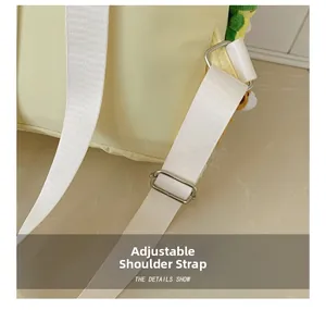 Detail of adjustable white padded shoulder strap with silver metal buckle on backpack