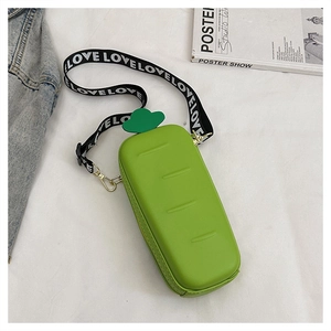 Detail showing creative carrot-shaped crossbody bag in bright green with wide love strap