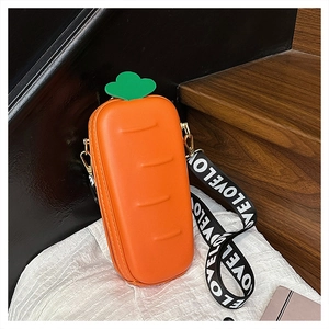 Detail of carrot shaped crossbody bag featuring green leaves and a wide LOVE strap