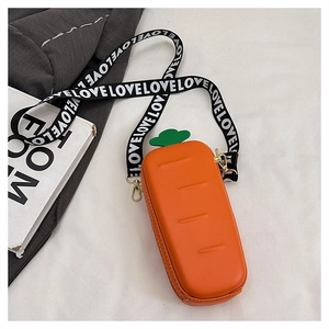 Close-up of carrot-shaped bag with orange leather texture and LOVE letter strap