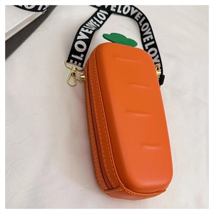 Detail view of the orange carrot shaped PU leather crossbody bag with letter strap