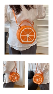 Detailed close-up of the orange slice design on a round creative fruit crossbody bag