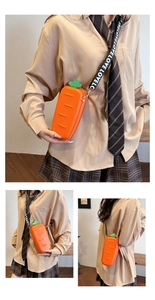 Macro detail of quirky orange carrot-shaped crossbody bag with green leaf design