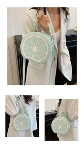 Detail of mint green lemon slice crossbody bag with gold hardware and adjustable strap