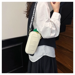 Detail of creative bread-shaped crossbody bag with white LOVE print shoulder strap