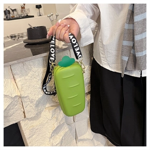Detail of carrot-shaped green crossbody bag with LOVE printed wide strap and gold hardware