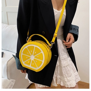 Detail of creative lemon fruit shaped crossbody bag with 3D citrus slice texture and handle