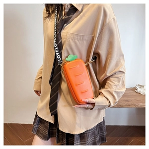 Detailed view of creative carrot-shaped PU leather crossbody bag with green leaf top