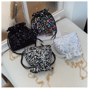 Detailed view of sequin bucket bags with drawstring closures and gold metal chain straps