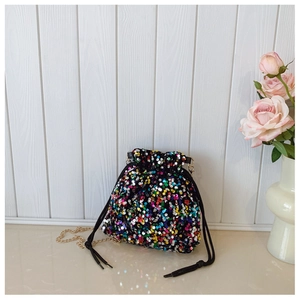 Detail of colorful sequins texture and gold chain on the fashionable bucket crossbody bag
