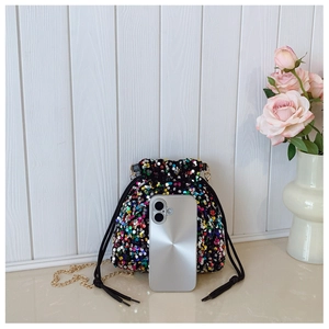 Detail of colorful sequin bucket bag with gold chain and phone for size reference