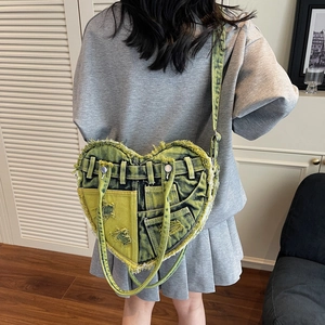 Y2K style heart-shaped denim crossbody bag with acid wash green finish and frayed edges