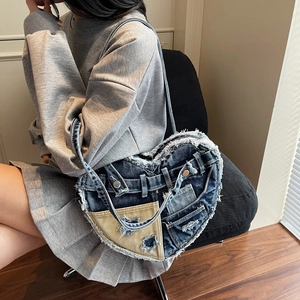 Heart-shaped denim shoulder bag with fringe trim and distressed star design for women