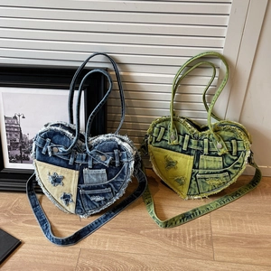 Heart-shaped denim crossbody bags with vintage washed frayed edges and star detail