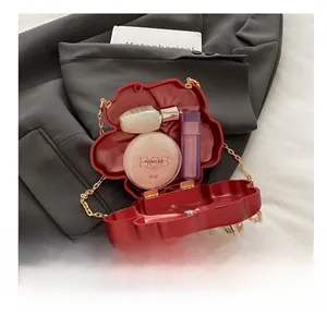 Macro shot of red floral evening bag showing interior space for lipstick and cosmetics