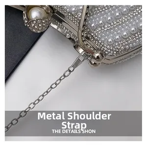 Macro shot of silver pearl evening bag showing metal chain strap and rhinestone details