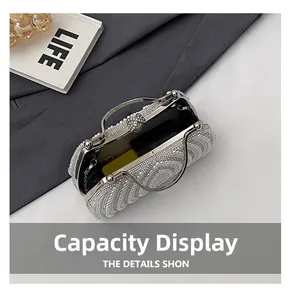 Detail view of the pearl evening bag interior showing capacity for a large smartphone