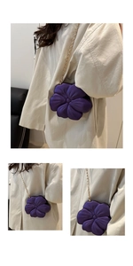 Detail of purple 3D flower-shaped bag with soft petals and a slim gold chain strap