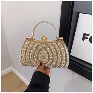 Close-up of pearl evening bag with champagne gold frame and elegant fan-shaped beadwork