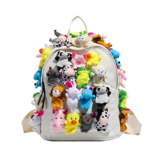 Cute white student backpack featuring various colorful plush animal doll charms for school