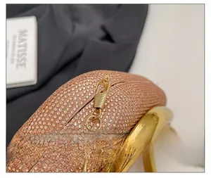 Detail show of luxury champagne gold rhinestone evening bag with elegant chain and ring handle