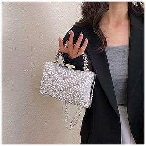 Close-up of pearl and rhinestone evening bag with elegant crystal handle and chain