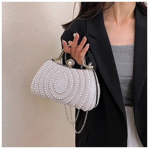 Detailed view of handmade pearl evening clutch bag with elegant metal chain and luxury texture