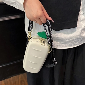 Cute carrot-shaped crossbody bag in cream white with green leaf decor and letter strap