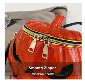 Detail of smooth golden double zippers on the festive pumpkin-shaped PU leather bag