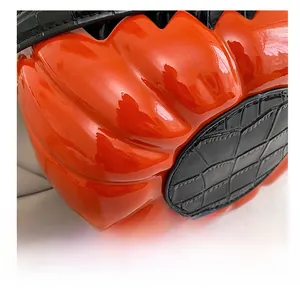 Close-up of the wear-resistant orange pumpkin bag base with black crocodile pattern leather