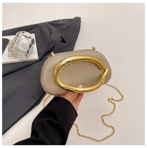 Detail of evening clutch featuring crystal rhinestones and oval gold metal handle