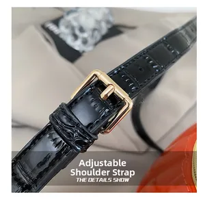 Macro detail of black crocodile texture leather strap with adjustable gold buckle