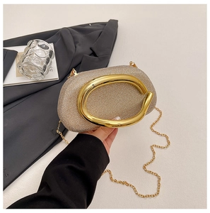 Detailed macro view of rhinestone evening clutch with bold gold metal ring handle