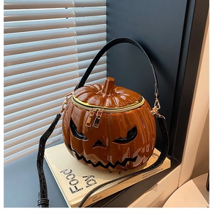 Macro detail of glossy brown pumpkin purse with black crocodile texture shoulder strap
