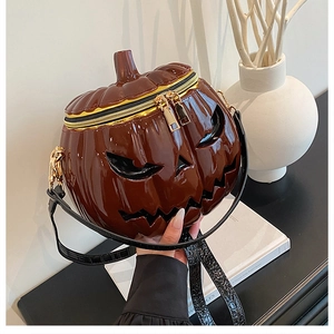 Detail of pumpkin crossbody bag featuring glossy PU leather and premium gold zippers