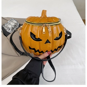 Close-up of 3D pumpkin crossbody bag featuring glossy orange finish and demon face detail