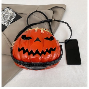 Top view of pumpkin shoulder bag with crocodile texture strap and phone for scale
