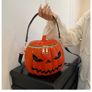 Detailed close-up of glossy orange Halloween pumpkin bag with black jack-o-lantern face