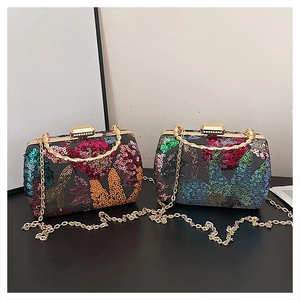 Detail of embroidered sequin evening bags with bamboo metal handles and chain straps