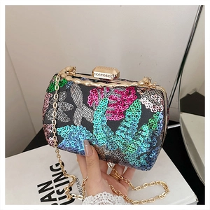 Detail of colorful sequin flower clutch with gold metallic frame and rhinestone clasp