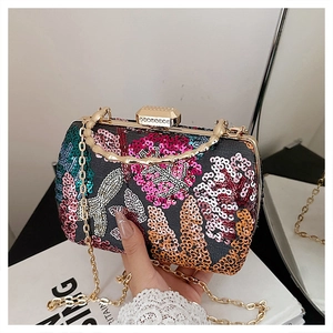 Detailed view of sequin flower embroidery on evening shell bag with bamboo handle