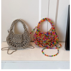 Close-up of metallic silver and colorful faceted bead weaving on handmade shoulder bags