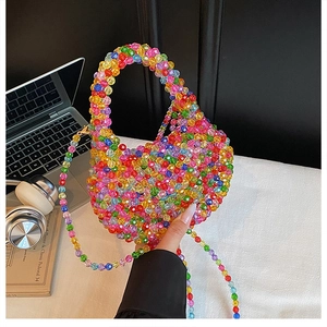 Close-up of handmade colorful acrylic beaded bag featuring rainbow heart shape design